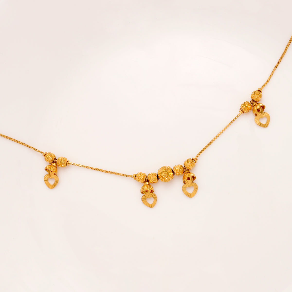 Regal Heart Drops Gold Ball Bracelet for Women